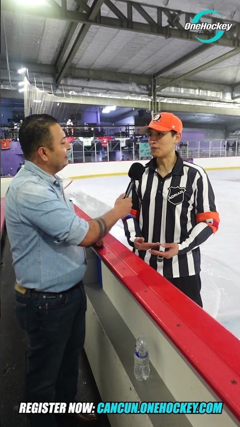 An official being interviewed at the boards of the Cancún rink during the first OneHockey tournament